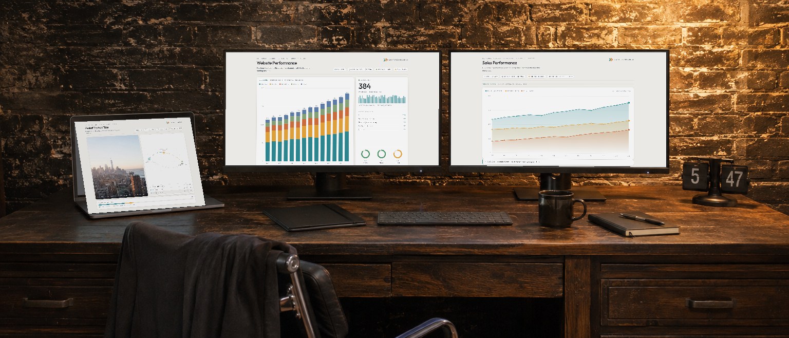 Explode: pages from one Showspace travelling across every screen on the desk — the acquisition model, the investment holdings and the sales figures, each on its own display in the same brick room.