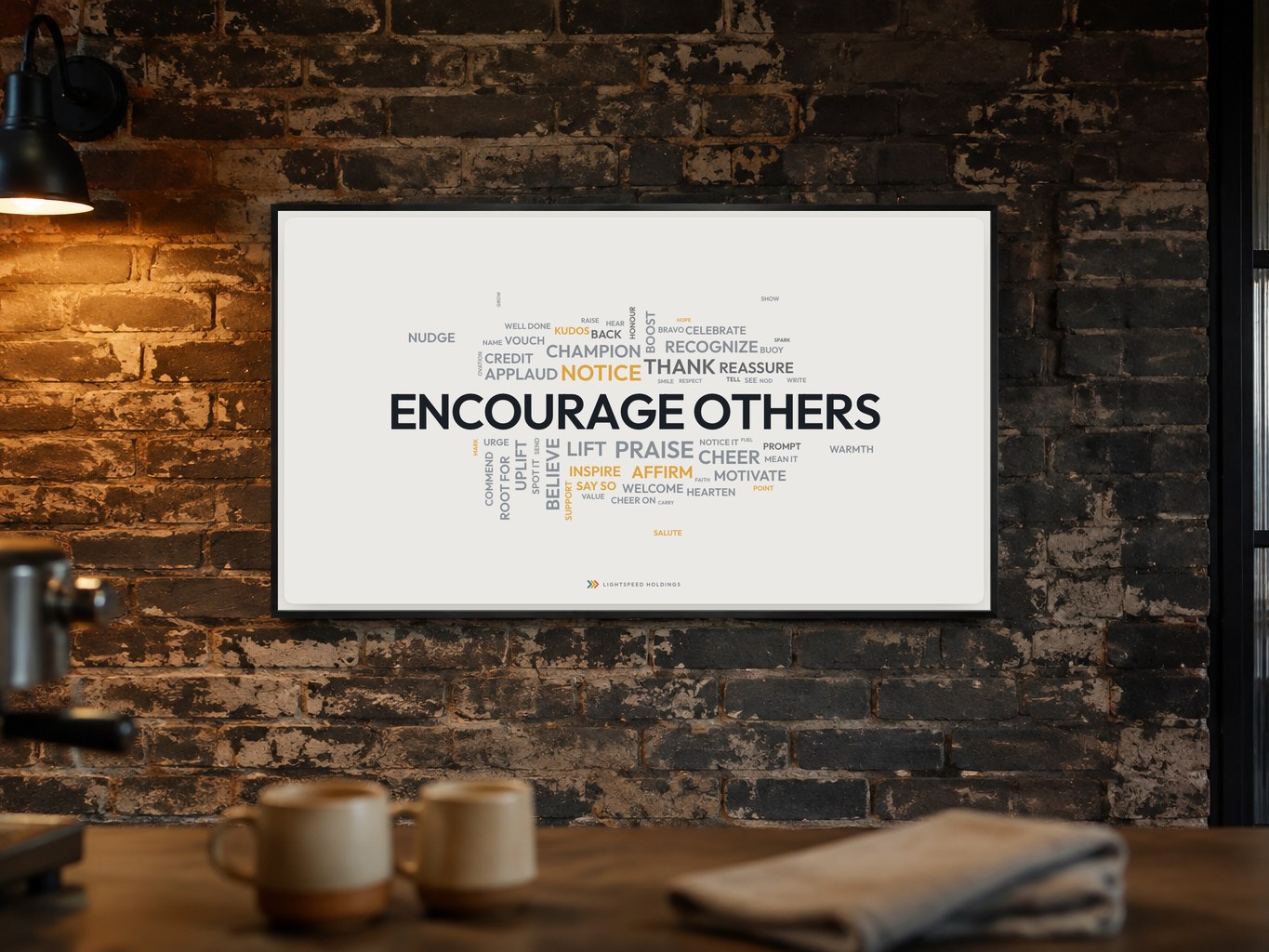 A word cloud &mdash; Encourage others &mdash; on the kitchen wall, there to be glanced at while the coffee pours.